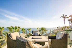 a patio with a table and chairs and the ocean at Villa Alegria in El Pueblito
