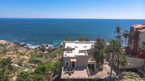 a house on a hill next to the ocean at Villa Alegria in El Pueblito