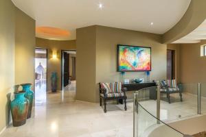 a lobby with two chairs and a painting on the wall at Villa Alegria in El Pueblito