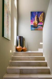 a stairway with two vases and a painting on the wall at Villa Alegria in El Pueblito