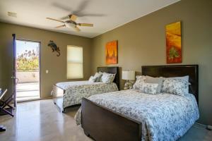 a bedroom with two beds and a ceiling fan at Villa Alegria in El Pueblito
