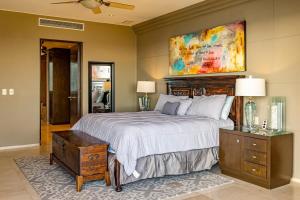 a bedroom with a bed and a painting on the wall at Villa Alegria in El Pueblito