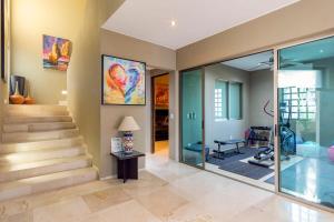 a home gym with stairs and a painting on the wall at Villa Alegria in El Pueblito