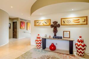 a living room with a table and vases on the wall at Villa Alegria in El Pueblito