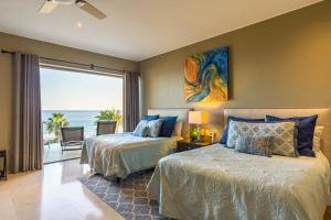 a bedroom with two beds and a view of the ocean at Villa Alegria in El Pueblito