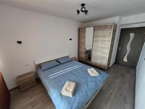 a bedroom with a large bed with two baskets on it at Cip Apartament Tazlaului in Bacău