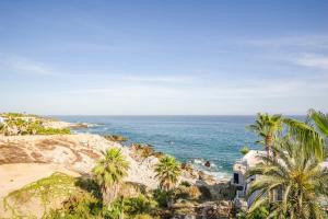 a view of a beach with palm trees and the ocean at Villa Alegria in El Pueblito