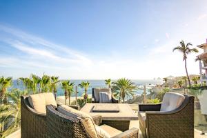 a patio with a table and chairs and the ocean at Villa Alegria in El Pueblito