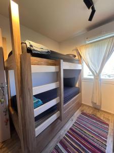 a bunk bed in a room with a window at Spacious 3BR Apartment w Rooftop Terrace Jacuzzi in Ras Elhekma