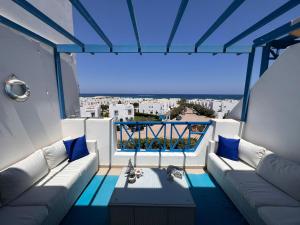 a balcony with a couch and a view of a city at Spacious 3BR Apartment w Rooftop Terrace Jacuzzi in Ras Elhekma