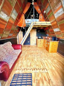 a room with a couch and a staircase in a house at Sparrow Cabin Hot Tub in Barham