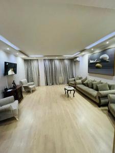 a large living room with couches and a table at ბინა131 in Tbilisi City