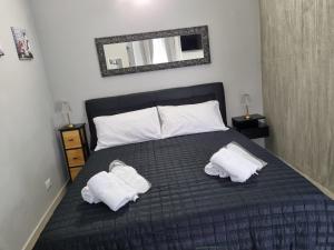 a bedroom with a bed with two towels on it at Cà Fiamma 2 in Casale Monferrato