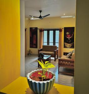 a living room with a couch and a plant at The Yellow Submarine in Varkala