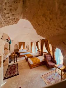 a large room with two beds and a couch at Mons Masius Hotel Teras in Midyat