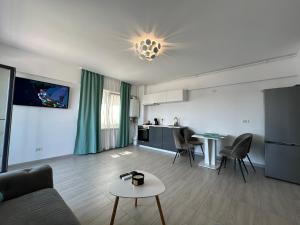 a living room with a couch and a table at Apartament Anne Marie - Ibo Residence in Mamaia Nord