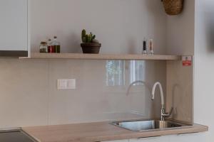 a kitchen with a sink and a counter at Ammos Stoupa - Cosy Casa in Stoupa +23 photos