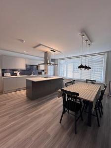 a kitchen with a table and chairs in a room at Apartment in North Norfolk in Cromer