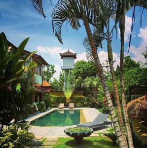 a house with a swimming pool and a tower at Sasa Bali Villas in Seminyak