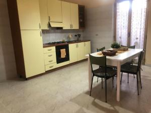 a kitchen with a table and some chairs and a stove at CasaLotto in Reggio di Calabria