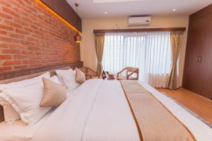 Ένα ή περισσότερα κρεβάτια σε δωμάτιο στο Temple Himalaya Hotel & Spa