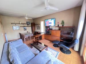 a living room with a couch and a television at Villa Gianfranca - sentiti come a casa in Corno di Rosazzo