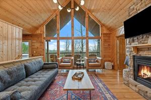 a living room with a couch and a fireplace at Pitch Perfect in Sevierville