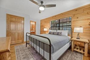a bedroom with a bed and a wooden wall at Pitch Perfect in Sevierville +37 photos