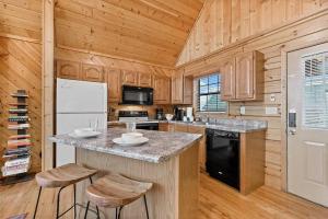 a kitchen with a counter top and a refrigerator at Pitch Perfect in Sevierville