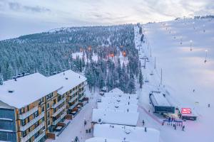 a view of a ski resort in the snow at Ski Chalet C8 Levi Center incl 2 ski passes by Aavalevi in Levi
