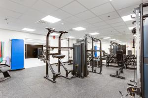 a gym with several treadmills and machines at Ski Chalet C8 Levi Center incl 2 ski passes by Aavalevi in Levi