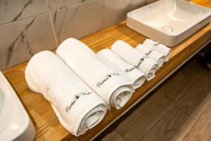 a bunch of towels on a counter next to a sink at Hotel Curtea Veche in Curtea de Argeş +55 photos