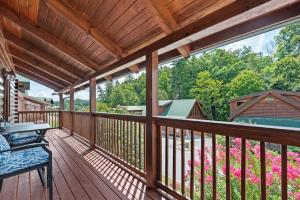 a wooden deck with a table and chairs on it at Bearly Behavin in Pigeon Forge