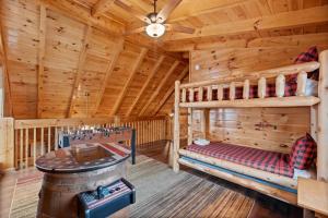 a bedroom with two bunk beds in a log cabin at Bearly Behavin in Pigeon Forge +29 photos