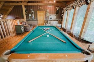 a pool table in the middle of a room at Big Kahuna Lodge cabin in Sevierville