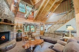 a living room with a couch and a fireplace at Big Kahuna Lodge cabin in Sevierville