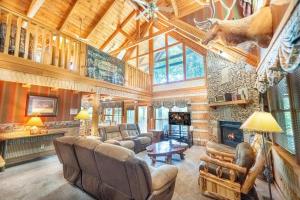 a living room filled with furniture and a fireplace at Big Kahuna Lodge cabin in Sevierville +58 photos