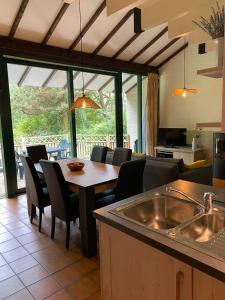 a kitchen and dining room with a table and chairs at Mon CoCoo in Stavelot