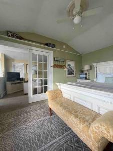 a living room with a couch and a bed at The Highland Cottage on Sheepscot in Edgecomb