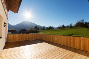 a wooden deck with a view of a mountain at Feriengut Suassbauer in St. Wolfgang
