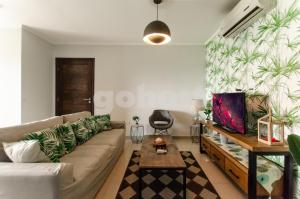 a living room with a couch and a tv at Hampton 2 Bedrooms Balcony And Bbq in Asuncion