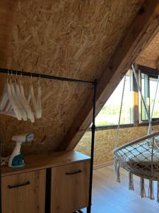 a room with a loft with a hammock in it at Lake house Zoya in Nikšić