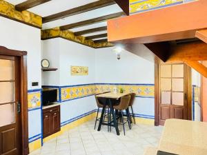 a kitchen with a table and chairs in a room at La Almadraba in Chiclana de la Frontera
