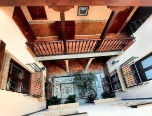 a building with a balcony with stairs and a door at Alhambra Catedral Centro in Granada