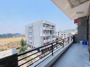 a balcony with a view of a building at ANAisha mansION Near Helipad Rajpur Road shastradhara Hill View in Dehradun