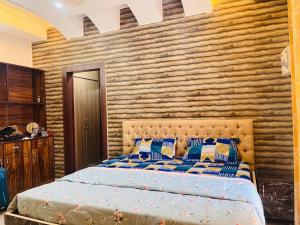 a bedroom with a bed and a wooden wall at ANAisha mansION Near Helipad Rajpur Road shastradhara Hill View in Dehradun