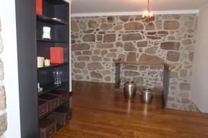 a fireplace in a room with a stone wall at Quinta do Correia in Cabeceiras de Basto