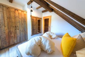 a bedroom with a bed with white sheets and pillows at Feriengut Suassbauer in St. Wolfgang