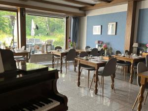 バート・ベリンゲンにあるHotel Markgrafのダイニングルーム(テーブル、ピアノ付)