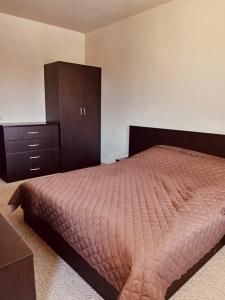 a bedroom with a bed and a dresser at View Apartment Bansko Royal Towers in Bansko +14 photos